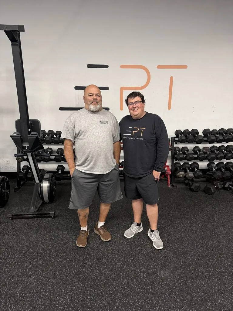 Patient and therapist in EPT shirts in the clinic gym